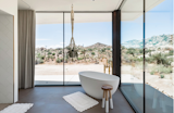 This villa has touches of Joshua Tree’s boho flair (think: hanging macrame planters, mudcloth pillows, and pops of pattern) but maintains an overall modern aesthetic. The palette of black and white hues comes with contemporary finishes like marble, wood, and stone with onyx accents. Outside, a saltwater pool, outdoor shower, and fire pit top off the three-acre gated retreat.&nbsp;