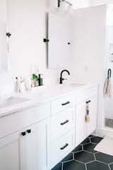 Bath, Laminate, Wall, Ceramic Tile, Enclosed, Drop In, and Two Piece The bathroom is clean and minimal to maintain a serene (and easy-to-clean) environment.  Bath Wall Laminate Photos from My House: A Wellness Blogger Carves Out a Soothing Retreat in Austin