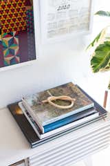The home is peppered with vignettes—here, a wood knot by artist Katie Gong tops a stack of art books. 