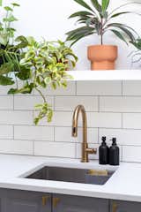 Kitchen, Engineered Quartz, White, Ceiling, Drop In, and Subway Tile They brightened up the space with white walls and luxe accents, keeping it minimal but with character.   Kitchen Drop In Ceiling Subway Tile Photos from My House: Two Bay Area Creatives Navigate a New Normal in Their Artist Co-Op
