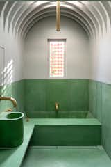 This concrete sink and matching tub, in a fetching shade of almost-Victorian green, creates harmony and adds personality to this space.