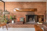 Living, Carpet, Chair, Standard Layout, Pendant, and Wood Burning One of two fireplaces in the home, this maintains all of the original brick from when the house was built.  Living Carpet Photos from A Magnetic L.A. Midcentury Arrives on the Market for the First Time Ever at $1.95M