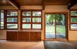 At the rear, sliding doors and wood-trimmed windows open to a verdant backyard.&nbsp;&nbsp;