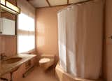 Each bedroom has its own full bathroom clad in pastel tiles.