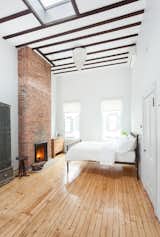 Three of the fireplaces in the home were rebuilt, including the pair in the main bedroom on the top floor, where a skylight punctures the high ceiling.