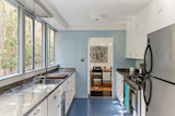 Blue tile accents the galley kitchen.