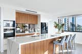 Mixed materials work in this kitchen because of the expansive and generous island, which allows for the material's textures to shine.