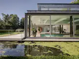 A Contemporary Villa in Belgium Comes Complete With a Landscape Pond and Showroom Garage - Photo 10 of 15 -