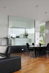 Dining Room, Lamps, Medium Hardwood Floor, Chair, Table, Ceiling Lighting, Recessed Lighting, and Pendant Lighting The dining room next to the kitchen  Photo 10 of 17 in White Snake house by AUM Pierre Minassian