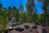 Outdoor, Back Yard, Trees, Boulders, Walkways, Hot Tub Pools, Tubs, Shower, Standard Construction Pools, Tubs, Shower, Landscape Lighting, Raised Planters, Wood Fences, Wall, Large Pools, Tubs, Shower, Retaining Fences, Wall, Infinity Pools, Tubs, Shower, Large Patio, Porch, Deck, Decking Patio, Porch, Deck, and Grass Second plateau including a fire pit and a spa  Photo 6 of 52 in M Resort and Spa by atelier paf.