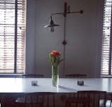 Hay chairs, white lacquer wood and aluminum table, light from Restoration Hardware