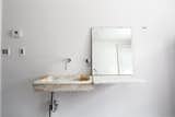 In the guest bathroom, Givone installed a hand-chiseled sink made of 17th-century marble quarried from the hills outside of Rome.