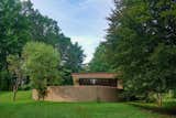 A curved concrete block wall conceals one of the three exterior terraces. Low-slung roofs appear to hover above the landscape.  Photo 2 of 14 in You Can Now Rent Frank Lloyd Wright's Gloriously Restored Eppstein House