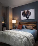 Words from Design Boss Gina:
The guest suite features a wood and steel headboard against a soft metallic blue wallpaper with a leather grain. The snowy buffalo art and layered textures creates the feeling of the perfect mountain retreat for guests.