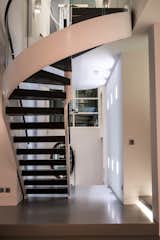 Curved timber, glass and leather staircase