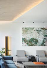 The dropped plaster ceiling was pulled away from the perimeter walls and finished with a razor thin edge. The concrete above is grazed with wash of light from a concealed source. The selection of furnishings was driven to find pieces that embodied as much beauty as comfort.