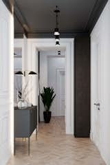 This minimal hallway’s white paint, light wood floor, and mirrored walls make it appear larger than it actually is.