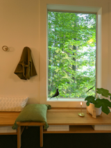 A large picture window was added to bring in views of the beautiful woods outside. This window is a game changer to the space that used to have minimal natural daylight. Now this peaceful haven is a witness to changing seasons and weather. The House Bird approves of the view!