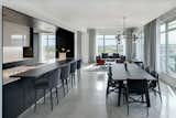 Dining Room, Chair, Table, Ceiling Lighting, Pendant Lighting, and Concrete Floor Social spaces are held to the perimeter to access expansive panoramic views.  Photo 6 of 10 in Whiteline Residence by Neumann Monson Architects