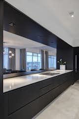 Dark-stained white oak and a marble counter top frames the kitchen.