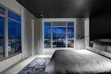 Bed, Ceiling Lighting, Accent Lighting, Wall Lighting, Concrete Floor, Rug Floor, and Bedroom Views to the south are reserved for the master bedroom.  Photo 8 of 10 in Whiteline Residence by Neumann Monson Architects