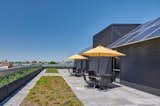 Rooftop gathering space with gardening beds and photovoltaic array