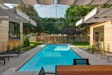 Outdoor, Grass, Back Yard, Concrete Patio, Porch, Deck, Hardscapes, Small Patio, Porch, Deck, Swimming Pools, Tubs, Shower, Trees, Wood Fences, Wall, Hanging Lighting, and Lap Pools, Tubs, Shower  Photo 6 of 15 in Koser II by Neumann Monson Architects