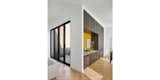 Hallway and Light Hardwood Floor Entry/ Bar & Courtyard  Photo 1 of 7 in Courtyard House by Collective Office - Architects