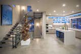 The second level kitchen is tucked behind the floating stairs while remaining open to the great room.