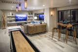 A fourth story penthouse game-room provides additional entertaining spaces and sweeping views of the valley and Strip.