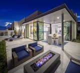 The main flooring, large format tile, continues through to the exterior, wood ceiling treatments on the inside extend to the outside patio helping to create a seamless transition between the inside and outside.