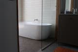 Tub in wet room of master bath.