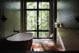 Bath, Pendant, Undermount, Soaking, Medium Hardwood, Two Piece, Open, Ceiling, Freestanding, and Subway Tile Master bath wet room with views of trees.  Bath Undermount Medium Hardwood Photos from Birch Le Collaboration House