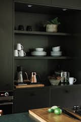 Hygge Supply cabinets with shelving inserts in kitchen.
