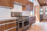 Stainless DCS and Fisher Paykel appliances in kitchen with walnut cabinets