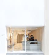 STUDIO ADJECTIVE LTD. - COFFEE SHOP INTERIOR PROJECT
www.adj.com.hk 
info@adj.com.hk 

The Facade 
The new café is located on Gough Street, one of the most charming spots in Central and the destination of famous brands, furniture stores and local restaurants. The elevation of the street is a busy palette of materials and showcases. Instead of creating another dramatic or fancy exterior, we decided to make a contrast with a minimalistic façade in glass, highlighting the coffee bar and the activities of the baristas and customers.