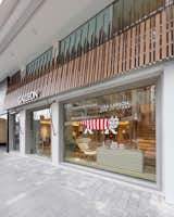 STUDIO ADJECTIVE LTD. - LIFESTYLE STORE INTERIOR PROJECT
www.adj.com.hk 
info@adj.com.hk

FAÇADE DESIGN
The team created a slanted façade panel with a mix of wooden and copper fins in varied widths to enhance the brand image from the street.
The roof-like design also exudes a homely atmosphere to the customers.