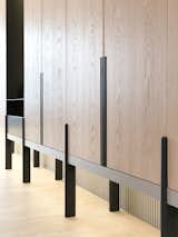 The custom-made cabinet wall with white washed oak panels and charcoal grey metal detail, resting in front of a striped backdrop. #studioadjective @studioadjective #apartment #home