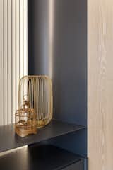 The custom-made cabinet wall with white washed oak panels and charcoal grey metal detail, resting in front of a striped backdrop. #studioadjective @studioadjective #apartment #home