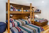 Kids Room, Toddler Age, Bedroom Room Type, Bed, Pre-Teen Age, Medium Hardwood Floor, Playroom Room Type, Bunks, Storage, and Boy Gender Kids' Bunk Room  Photo 9 of 14 in Ski in/ Ski Out Row House by Mary Beth Childs