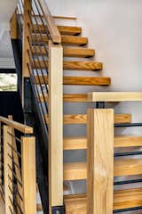 Staircase, Wood Railing, Wood Tread, and Metal Railing Open Stair - Vermont Ash treads with custom steel stringer  Photo 11 of 14 in Ski in/ Ski Out Row House by Mary Beth Childs