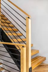 Staircase, Wood Railing, Metal Railing, and Wood Tread Stair Detail  Photo 14 of 14 in Ski in/ Ski Out Row House by Mary Beth Childs