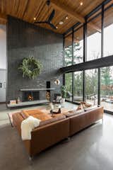 Living Room, Accent Lighting, Concrete Floor, Standard Layout Fireplace, Ceiling Lighting, Sectional, Chair, Floor Lighting, Recessed Lighting, Wood Burning Fireplace, and Coffee Tables Living room  Photo 7 of 16 in The Greenhills House by Craig Wollen