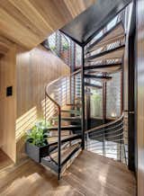 The stair lightwell uses the stack effect to draw cool air from the concrete slab and masonry wall spaces of the ground floor up through the bedroom and living spaces above, pushing hot air out the operable glass skin on the top floor in the warmer months.