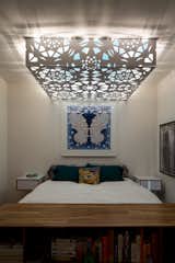 Custom light fixture employs aluminum screens used on the building exterior