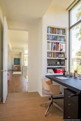 Office, Study Room Type, Chair, Shelves, Desk, Storage, Bookcase, Lamps, Medium Hardwood Floor, Rug Floor, and Carpet Floor  Photo 19 of 22 in Open House by Murphy Mears Architects