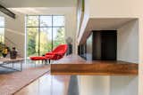Living Room, Coffee Tables, Chair, Ottomans, Gas Burning Fireplace, Ribbon Fireplace, Corner Fireplace, Concrete Floor, Rug Floor, Ceiling Lighting, and Track Lighting  Photo 9 of 22 in Open House by Murphy Mears Architects