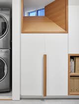 Disguising the functional elements of the basement neatly among easily accessible organized storage.