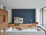 Living Room, Sofa, Coffee Tables, Rug Floor, Chair, Ottomans, Storage, and Light Hardwood Floor The open-concept living room is washed with bright east morning light from the sliding glass doors from the lower patio.  Photo 7 of 11 in Hazel Flat by Barbora Vokac Taylor Architect