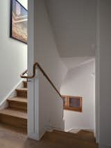 The handrail serves as a familiar and steady guide from entry up to the third floor.